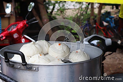 Steamed buns are a kind of Chinese food made from wheat flour and yeast and brought through the steaming process. Stock Photo