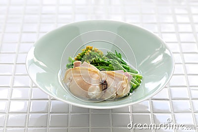 Steamed clams and field mustard in rice wine Stock Photo