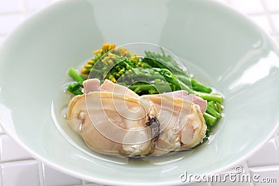 Steamed clams and field mustard in rice wine Stock Photo