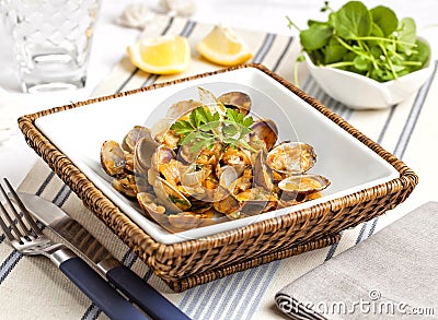 Steamed clams served on the table of an outdoor seafood restaurant. Stock Photo