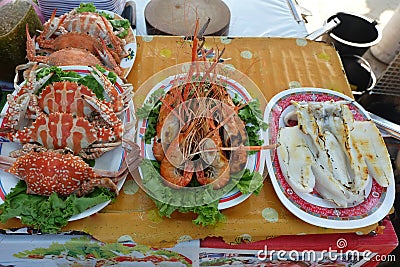 Steamed crab, grilled prawns and roast squid or grilled squid On the plate Stock Photo