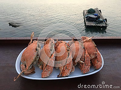 Steamed crabs plate by a tropical beach Stock Photo