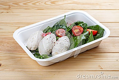 Steamed cutlets made of three kinds of meat. Healthy diet. Takeaway food. Eco packaging. On a wooden background Stock Photo