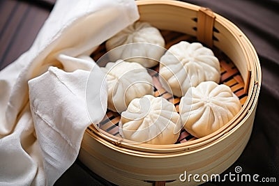steamed dumplings in a wicker hamper with a linen napkin Stock Photo