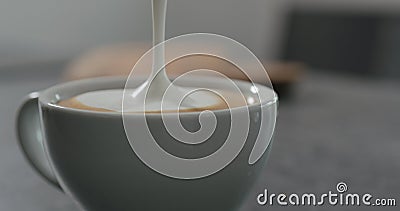Steamed milk pour into coffee making cappuccino Stock Photo