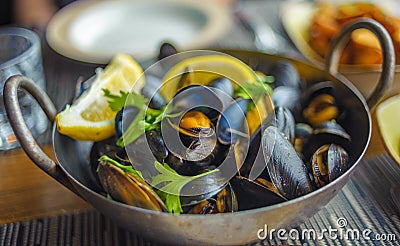 Steamed mussels in a pot. Delicious seafood plate Stock Photo