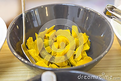 Steamed pumpkin cut in small pieces in ceramic bowl at the dessert restaurant in Thailand Stock Photo