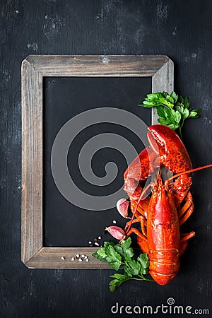 Steamed red lobster on a blackboard with copyspace Stock Photo