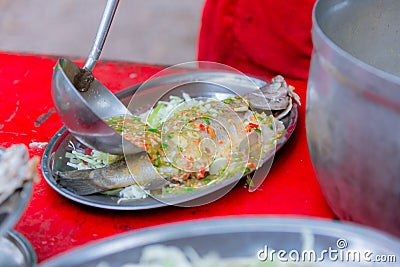 Steamed sea bass fish with lemon, Thai famous local food served on fish shape plate. Thai recommend menu for tourist. Steamed fish Stock Photo