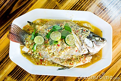 Steamed thai flavor sour and spicy fish served on the plate Stock Photo