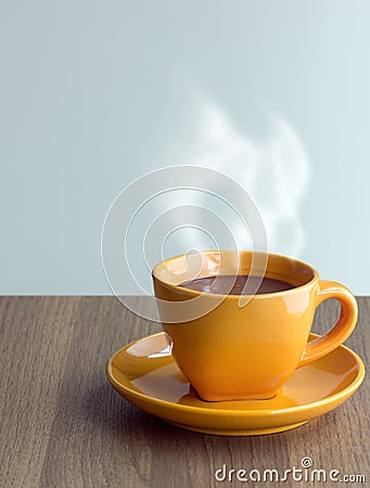 Steaming coffee cup on table Stock Photo