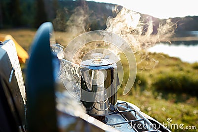 Steaming pot of coffee over a gas burner Stock Photo