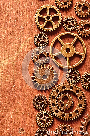 Steampunk mechanical cogs gears wheels on wooden background Stock Photo