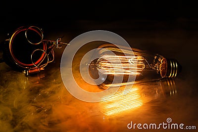 A steampunk scene with a victorian feel, bathed in warm orange light produced by the edison style lightbulb Stock Photo