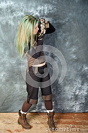 Steampunk-styled girl experiments with old camera Stock Photo