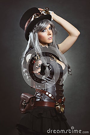 Steampunk woman aiming with gun Stock Photo