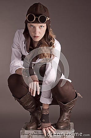 Steampunk woman wearing brown kneeling Stock Photo