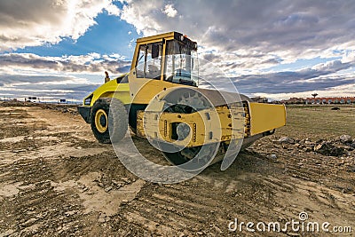 Steamroller performing leveling work on a road under construction Stock Photo