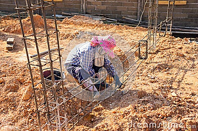 Steel Beam tied to a pillar and tied before topping the building structure. Stock Photo