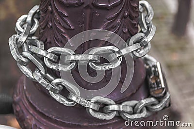 Steel chain around a pole Stock Photo