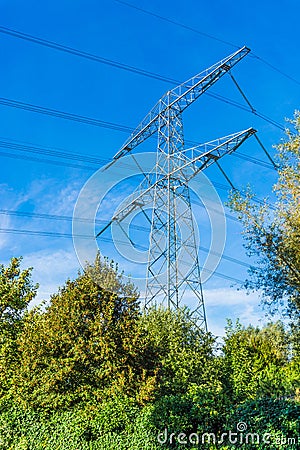 Steel electricity power tower construction in a nature landscape with blue sky Stock Photo