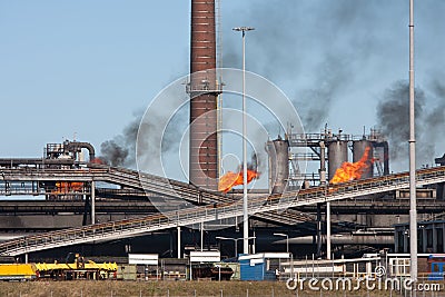 Steel factory with smokestack and gas flaring Stock Photo