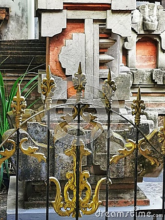 Steel gold-ornamented gate of a balinese hindu temple on Bali island in Indonesia Stock Photo