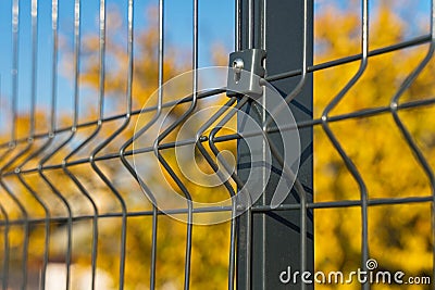 Steel grating fence made with wire on blue sky background. Sectional fencing installation. Stock Photo