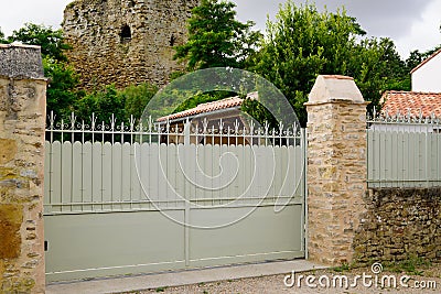 Steel green clear metal gate in street view of fence on modern house Stock Photo