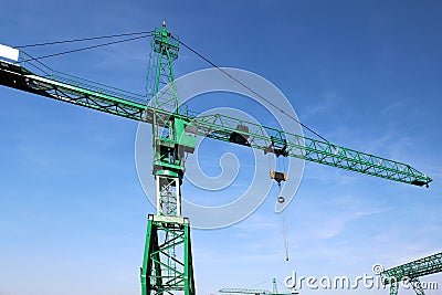 Steel green high crane under blue sky Stock Photo