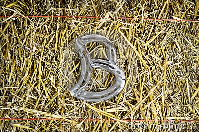 Letter B Steel Horseshoe on Straw Stock Photo