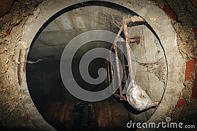 Steel ladder in technical descent into underground sewage system, sewerage hole Stock Photo