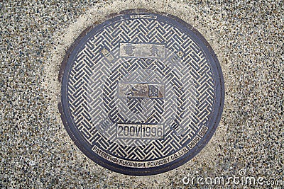 Steel manhole cover or metal sewer on the street in Japan Editorial Stock Photo