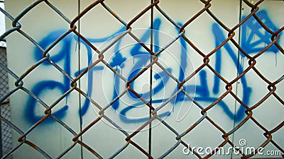 Steel mesh in front of graphic wall Stock Photo