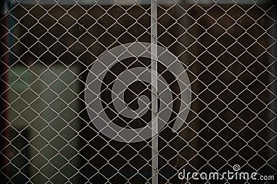 Steel mesh is used as temporary fence to mark boundaries of private property because it is durable and easy install as fence. Stock Photo