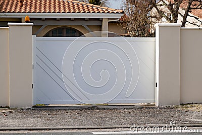 Steel modern white gate aluminum portal with blades design of suburban house Stock Photo