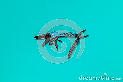 Steel multi tool on the blue background Stock Photo