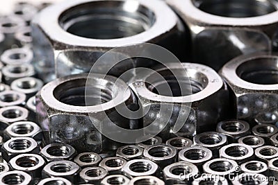 Steel nuts and screws on mirror Stock Photo