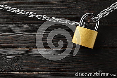 Steel padlock, chain and space for text on black background, top view. Safety concept Stock Photo