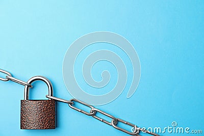 Steel padlock, chain and space for text on blue background, top view. Safety concept Stock Photo