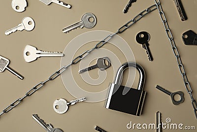 Steel padlock, keys and chains on beige background. Safety concept Stock Photo