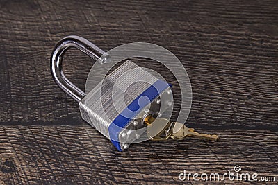 Steel Padlock on a Wooden Background Stock Photo