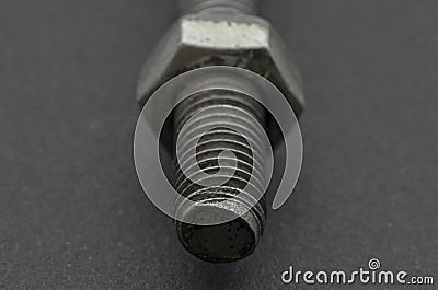 Steel pigtail screw hook on black background. Stock Photo