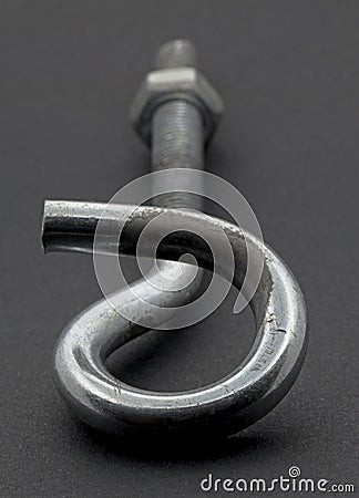 Steel pigtail screw hook on black background. Stock Photo