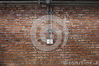 Steel pipe electric wire and plug on vintage brick wall backgrou Stock Photo