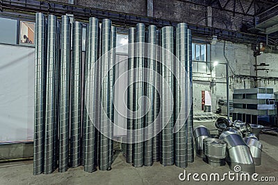 Steel pipes and other parts for construction of ducts of industrial air condition system in the warehouse Stock Photo