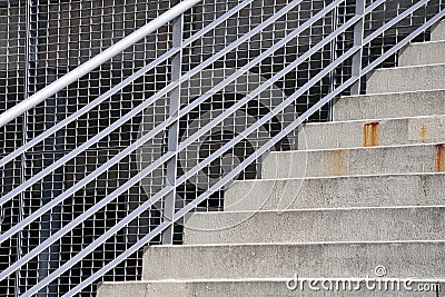 Stairway alongside facade with metal grid Stock Photo