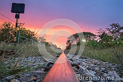 Steel railroad and signpost at twilight sky Stock Photo