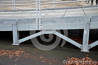 Steel ramp for the entry of supply trucks into an industrial hall or supermarket. solid galvanized construction with railings for Stock Photo