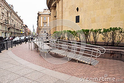 Steel Ramp for wheelchairs at subway entrance on street. Metal ramp for people Editorial Stock Photo